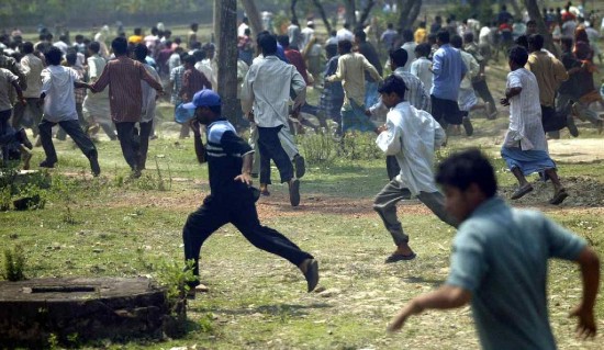 Villagers run as police fire teargas shells in Nandigram, 15 March 2007. Photo Credits: Reuters. 