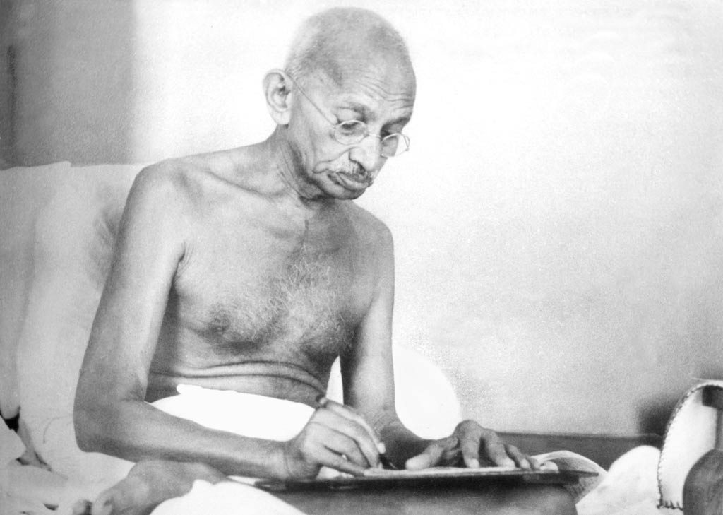 Gandhi writing a letter